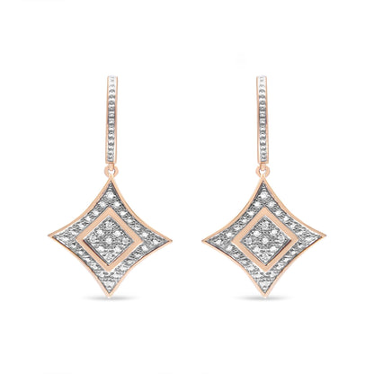 Front view of a pair of rose metal drop earrings with diamond-shaped pendants adorned with white gemstones in pave setting.