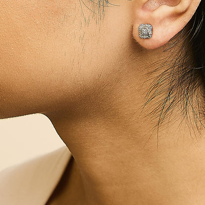 Close-up side view of a model wearing square-shaped white metal stud earrings featuring multiple round white gemstones in prong settings.