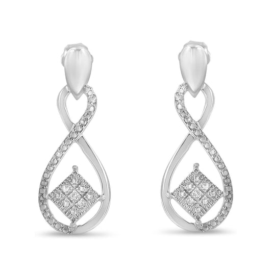 Front angle view of white metal earrings with an infinity loop design, pavé set with small white round gemstones, and a square cluster of white gemstones at the center.
