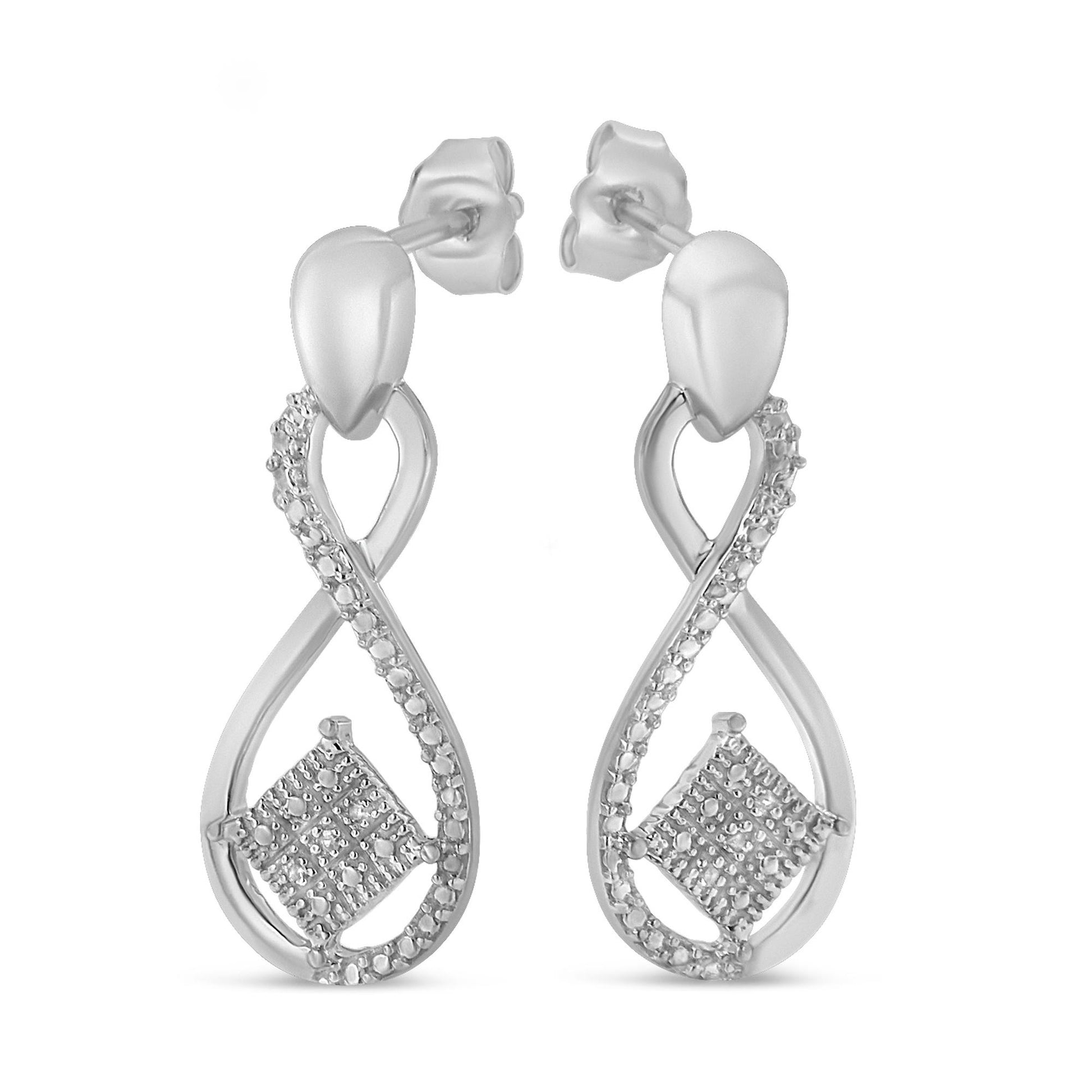 Front angle view of a pair of white metal earrings featuring an infinity loop design with pave-set round white gemstones along one side and a cluster of round white gemstones arranged in a square shape near the bottom.