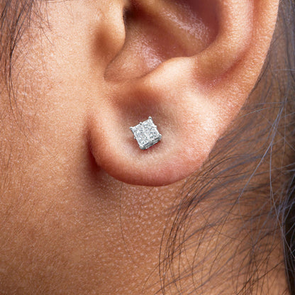 Close-up side view of a white metal stud earring with multiple princess-shaped white gemstones in an invisible setting, worn on a model's ear.