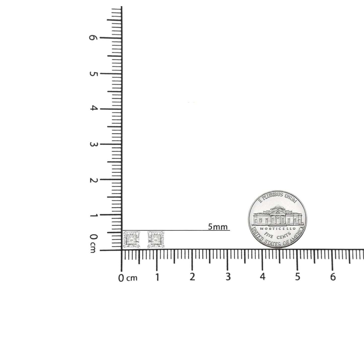 Top-down view of white metal princess shape earrings with white gemstones, shown on a ruler and next to a coin for size reference.