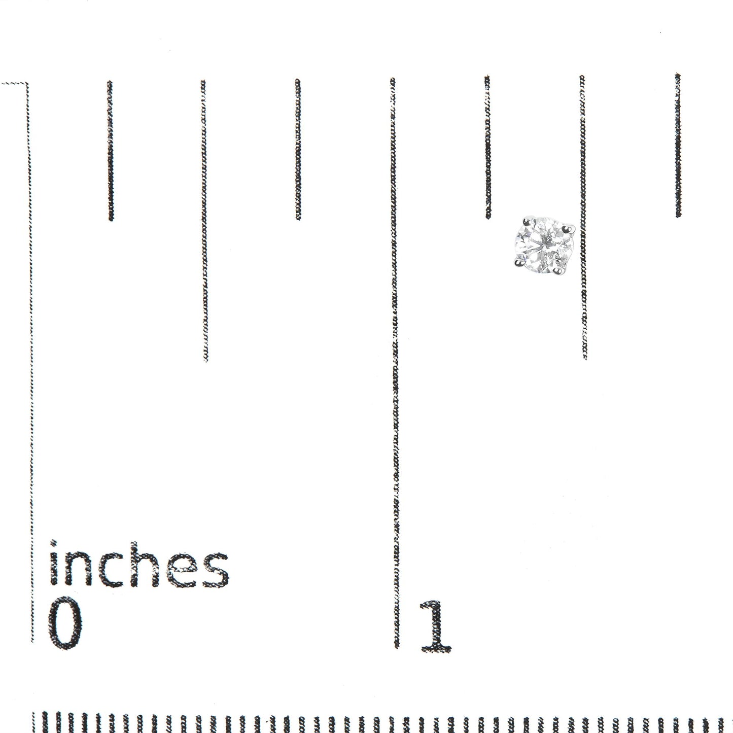 Close-up front angle of a single white metal stud earring with a round white gemstone in a four-prong setting on a ruler for size reference.
