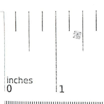Close-up front angle of a single white metal stud earring with a round white gemstone in a four-prong setting on a ruler for size reference.