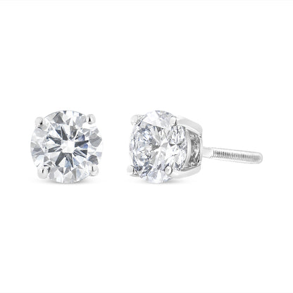 Pair of white metal stud earrings with round white gemstones in prong settings, shown from front and side angles.
