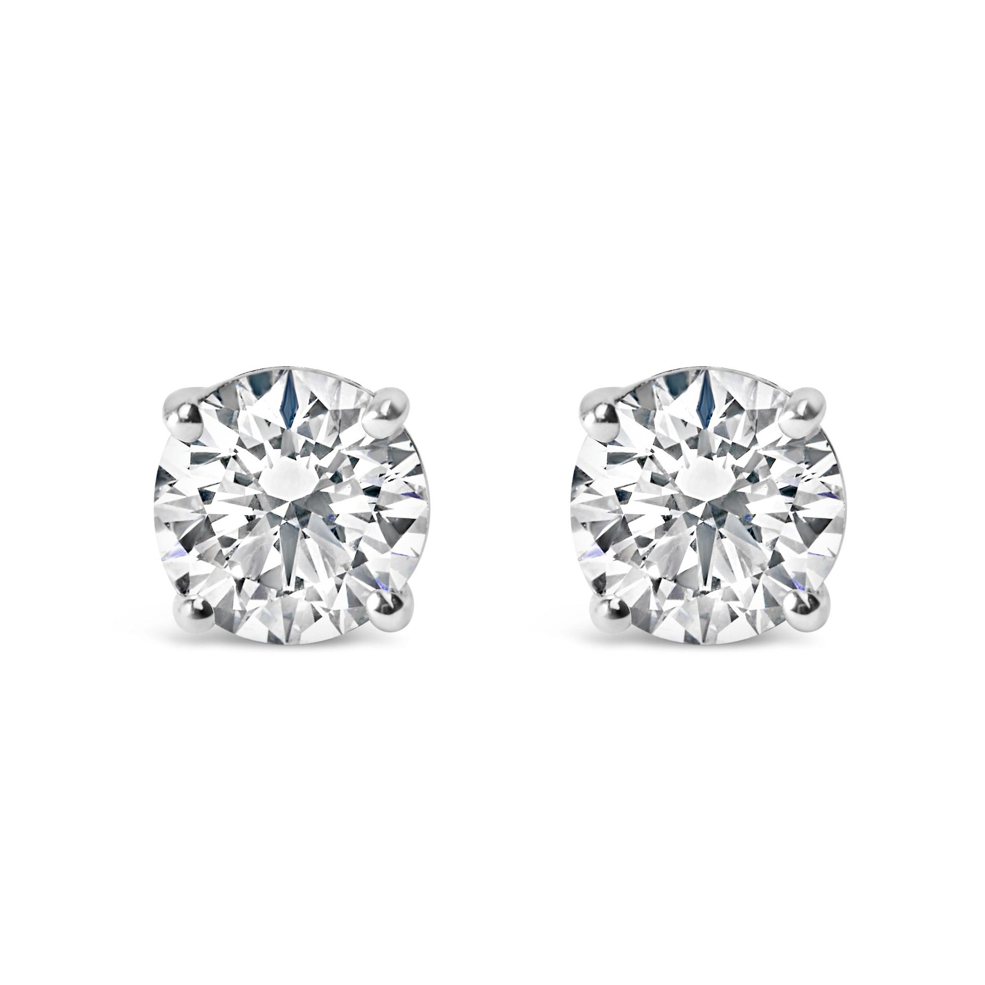 Pair of white metal stud earrings with round white gemstones in four-prong settings, front view on white background.