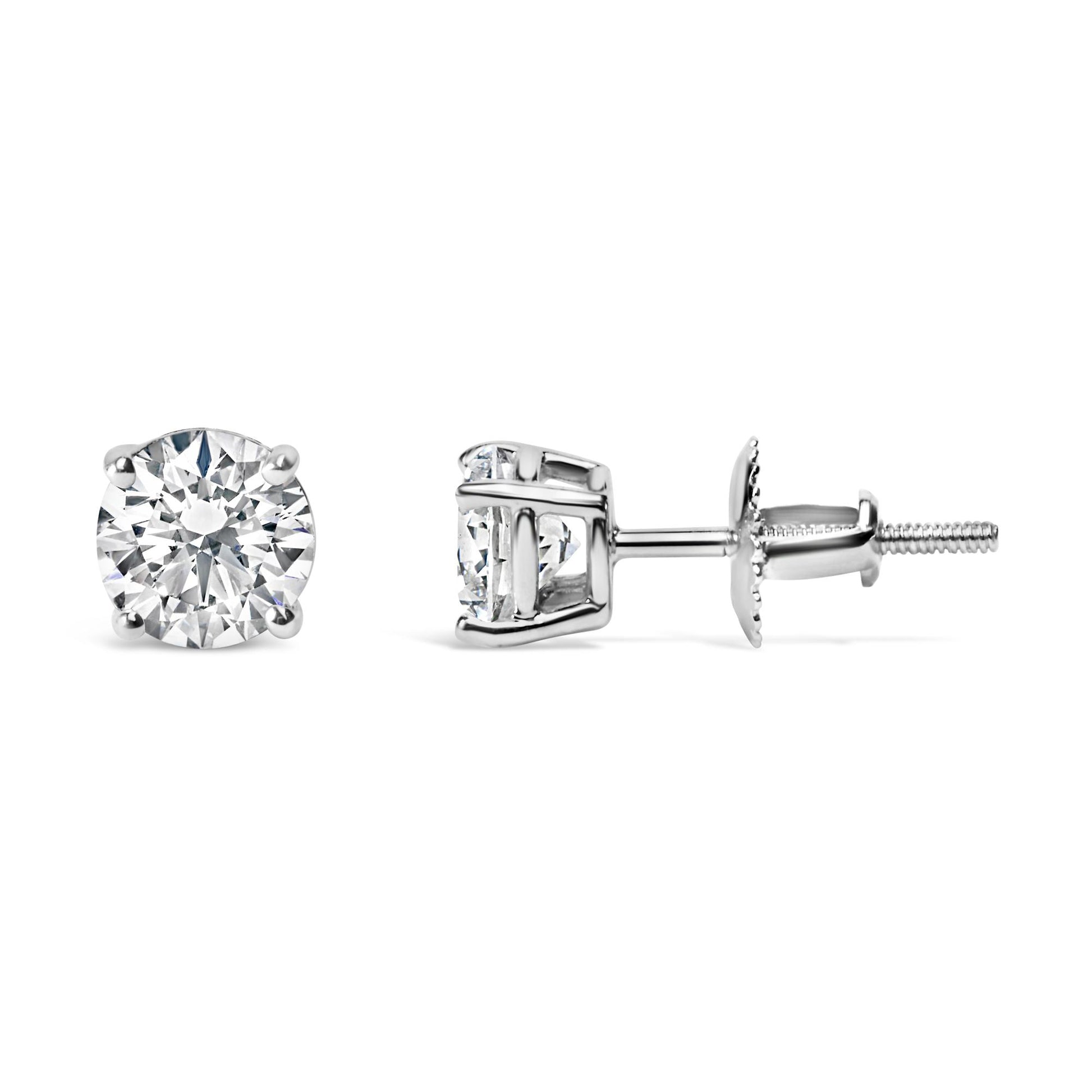 Pair of white metal stud earrings with round white gemstones in four-prong settings, shown from front and side angles.