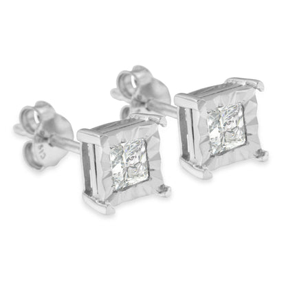 Pair of white metal stud earrings with princess-shaped white gemstones in a miracle setting, shown from a slight side angle.