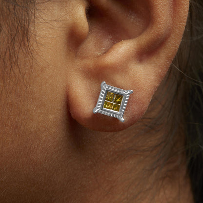 Close-up side angle of a model wearing square-shaped white metal stud earring with four yellow princess-cut gemstones in an invisible setting.