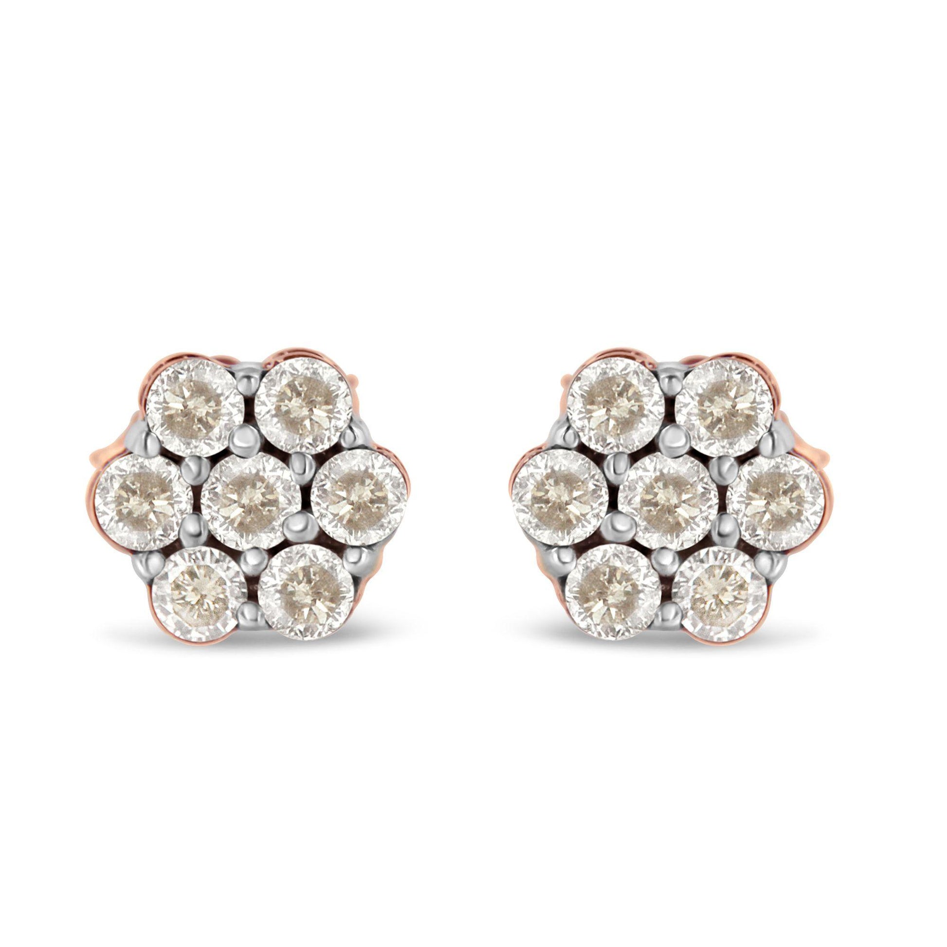 Front view of a pair of rose metal stud earrings with round white gemstones in a cluster design.