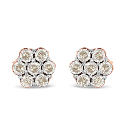 Front view of a pair of rose metal stud earrings with round white gemstones in a cluster design.