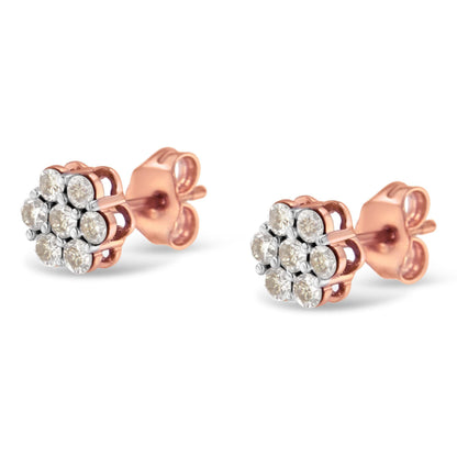 Pair of rose metal stud earrings with round white gemstones in prong settings, shown from a front angle on a white background.