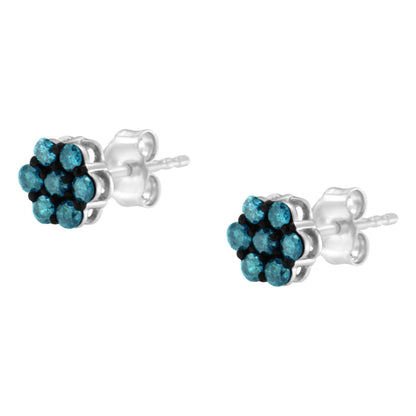 Pair of white metal stud earrings with cluster of round blue gemstones in prong settings, shown from a front angle.