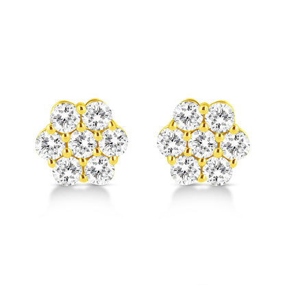 Front view of a pair of yellow metal stud earrings each with multiple round white gemstones in prong settings arranged in a floral pattern.
