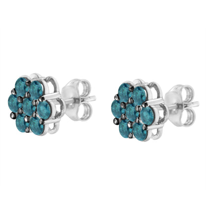 Close-up front angle of white metal stud earrings with clusters of round blue gemstones in prong settings.