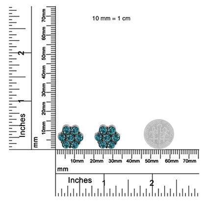 Pair of white metal stud earrings with round blue gemstones arranged in a floral cluster design, shown from the front on a ruler and scale for size reference.