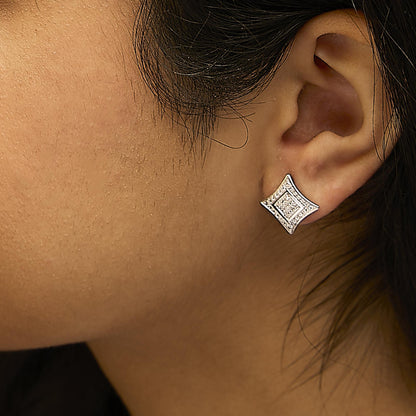 Close-up side view of a white metal earring with a geometric shape featuring round white gemstones in pave setting, worn on a model.