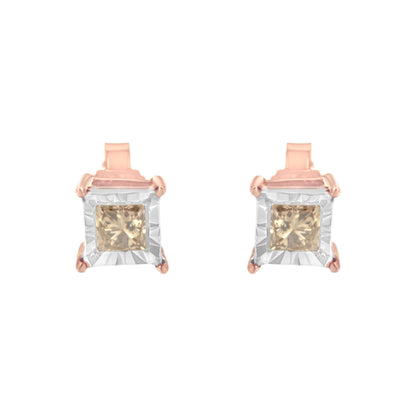Front view of white and rose metal earrings featuring square white frames and brownish princess-shaped gemstones in a miracle setting.