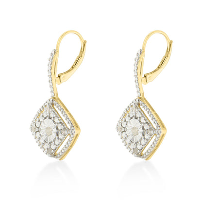Pair of yellow metal earrings with a geometric shape decorated with round white gemstones in prong settings, shown from the front angle.