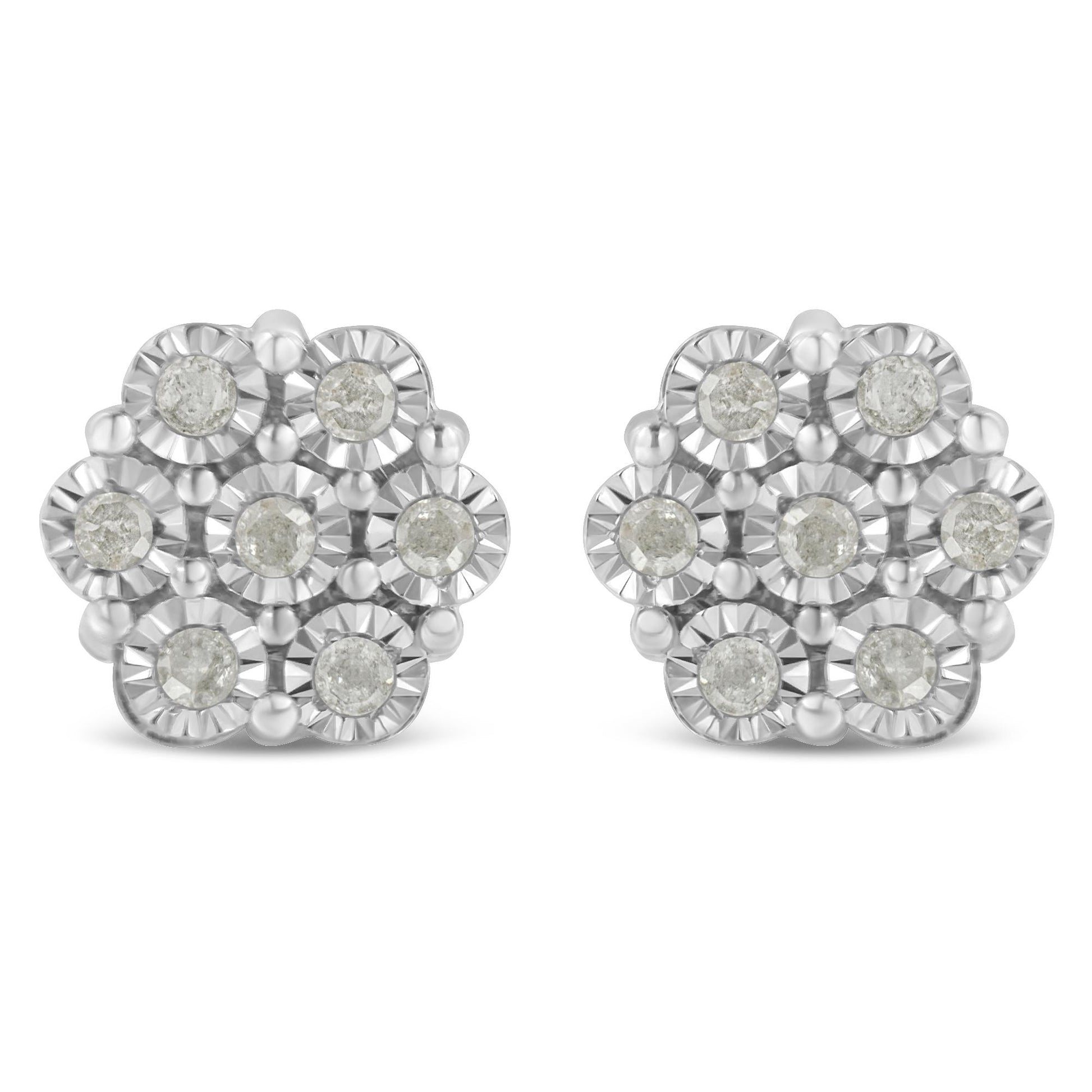 Front angle view of white metal earrings with round white gemstones arranged in a floral cluster design.