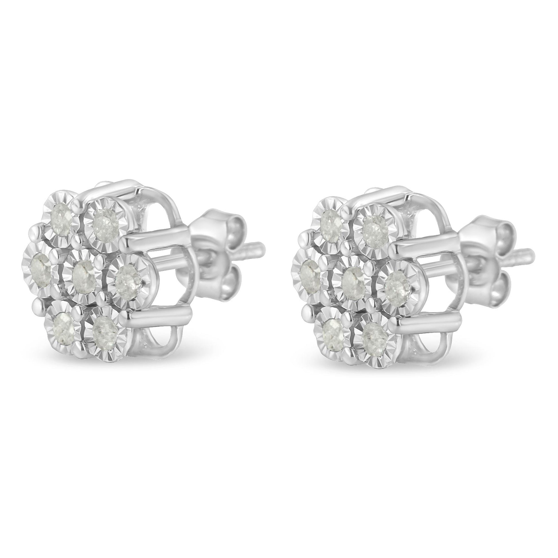 Pair of white metal stud earrings with round white gemstones arranged in a floral cluster, shown from a left side angle.