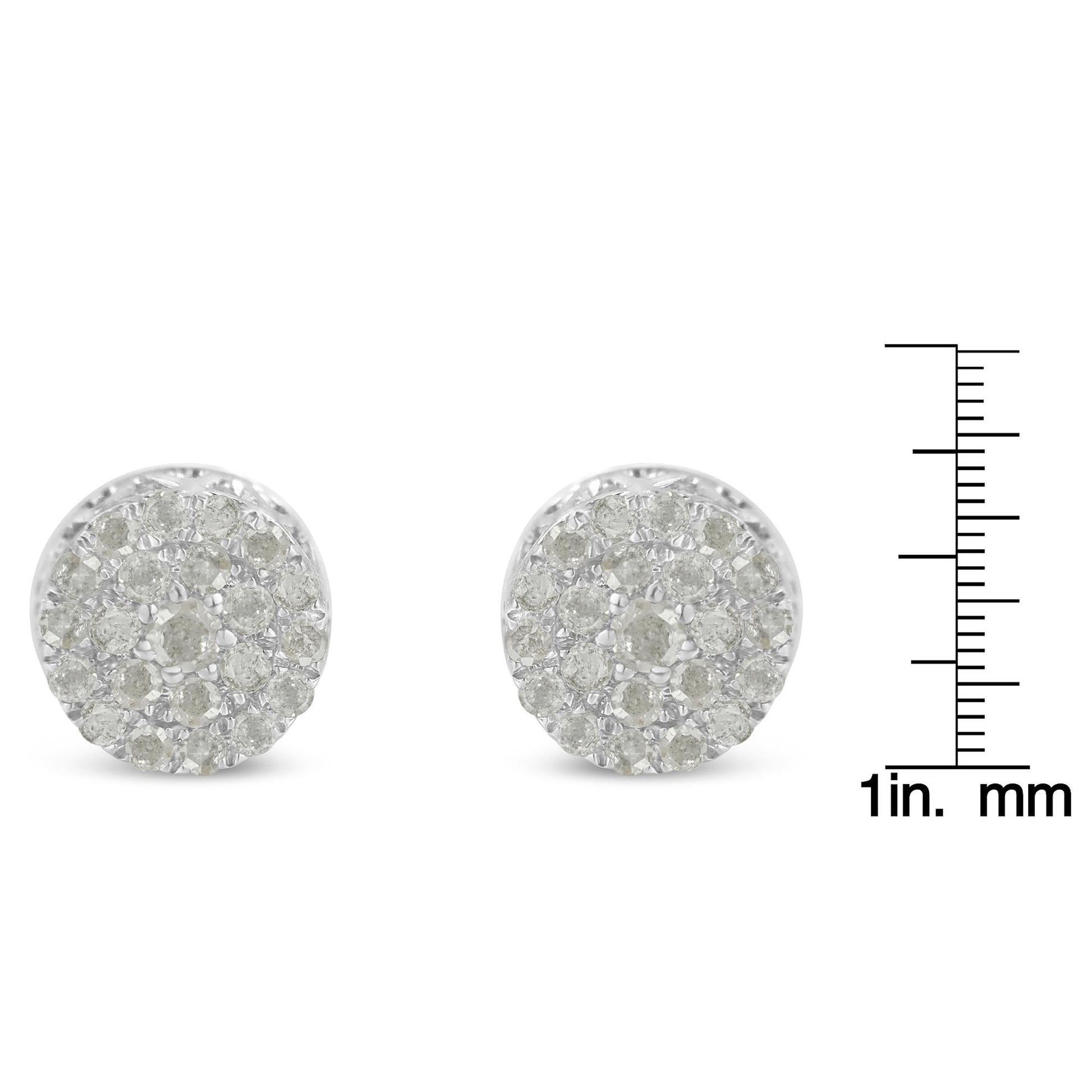 Front angle view of a pair of white metal round pave set white gemstone stud earrings next to a ruler for size reference.