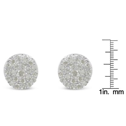 Front angle view of a pair of white metal round pave set white gemstone stud earrings next to a ruler for size reference.