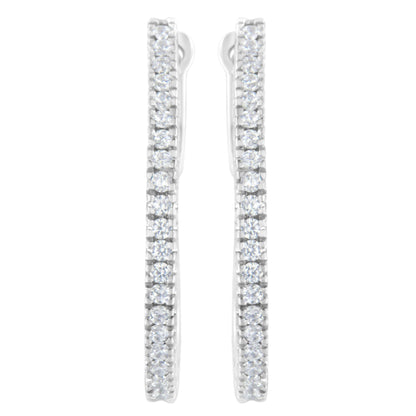 Front view of white metal earrings with vertical rows of round white gemstones in prong settings.