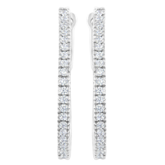 Front view of white metal earrings with vertical rows of round white gemstones in prong settings.