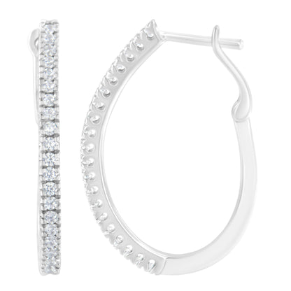 Close-up front and side view of white metal hoop earrings with round white gemstones in prong settings along the outer edge.