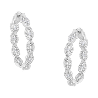 Front angle view of white metal hoop earrings with an intertwined twisted design, each encrusted with numerous small white gemstones in prong settings.