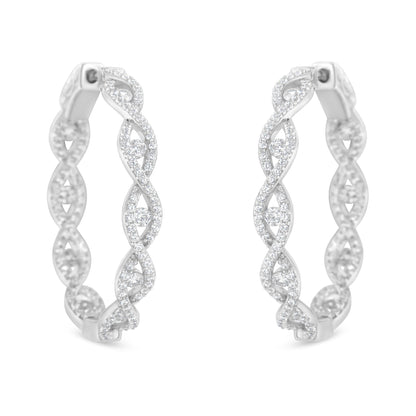 Front-facing close-up of white metal hoop earrings with intertwined design, adorned with multiple round white gemstones in prong settings.