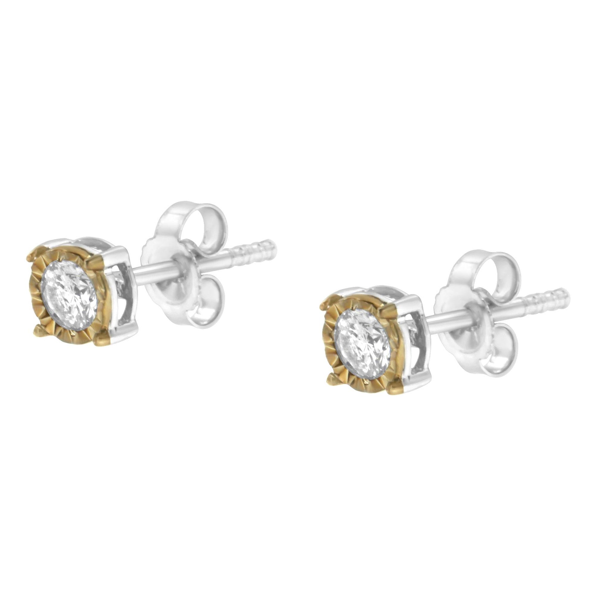 Pair of two-toned stud earrings with round white gemstones, shown from a side angle.
