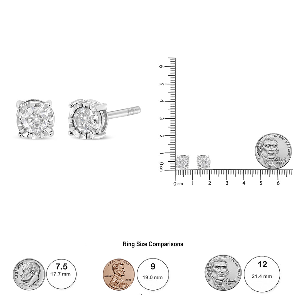 Close-up front and side view of white metal stud earrings with round shaped brownish gemstone in miracle setting, shown next to a ruler and coin for size reference.