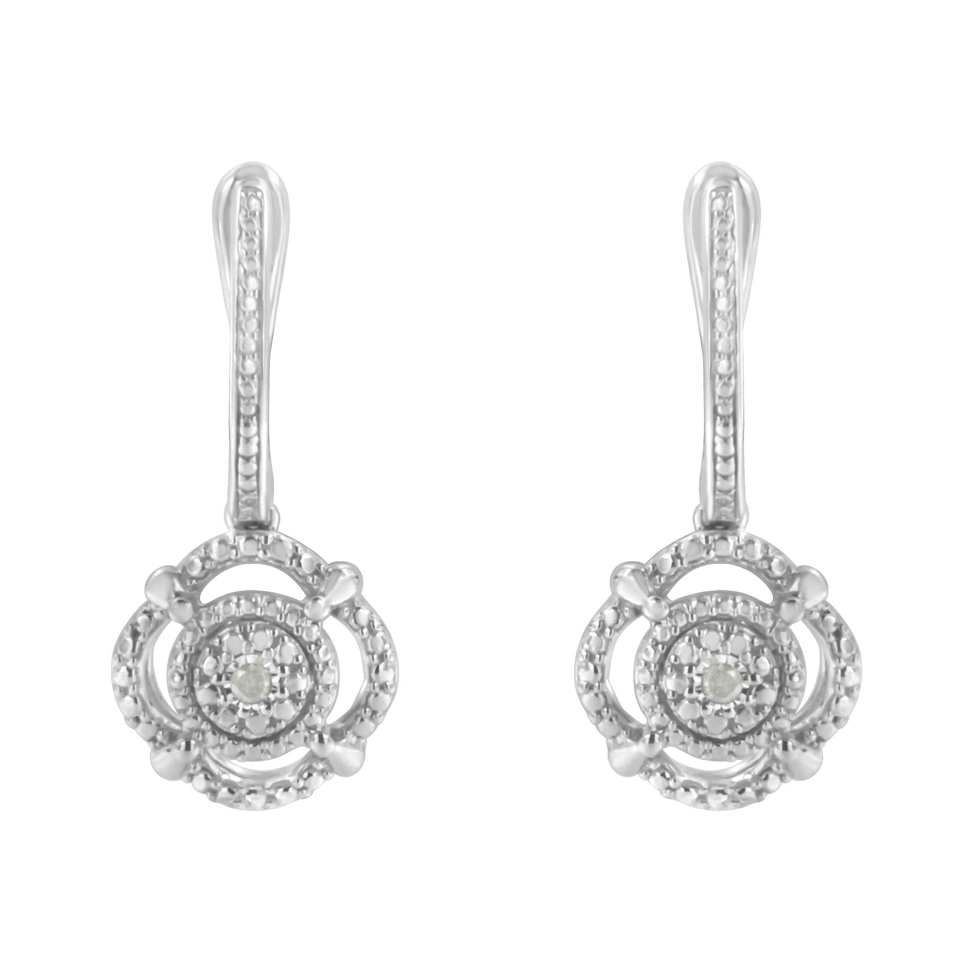Front-facing view of white metal earrings with round white gemstones in miracle settings.