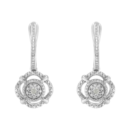 Front-facing view of white metal earrings with round white gemstones in miracle settings.