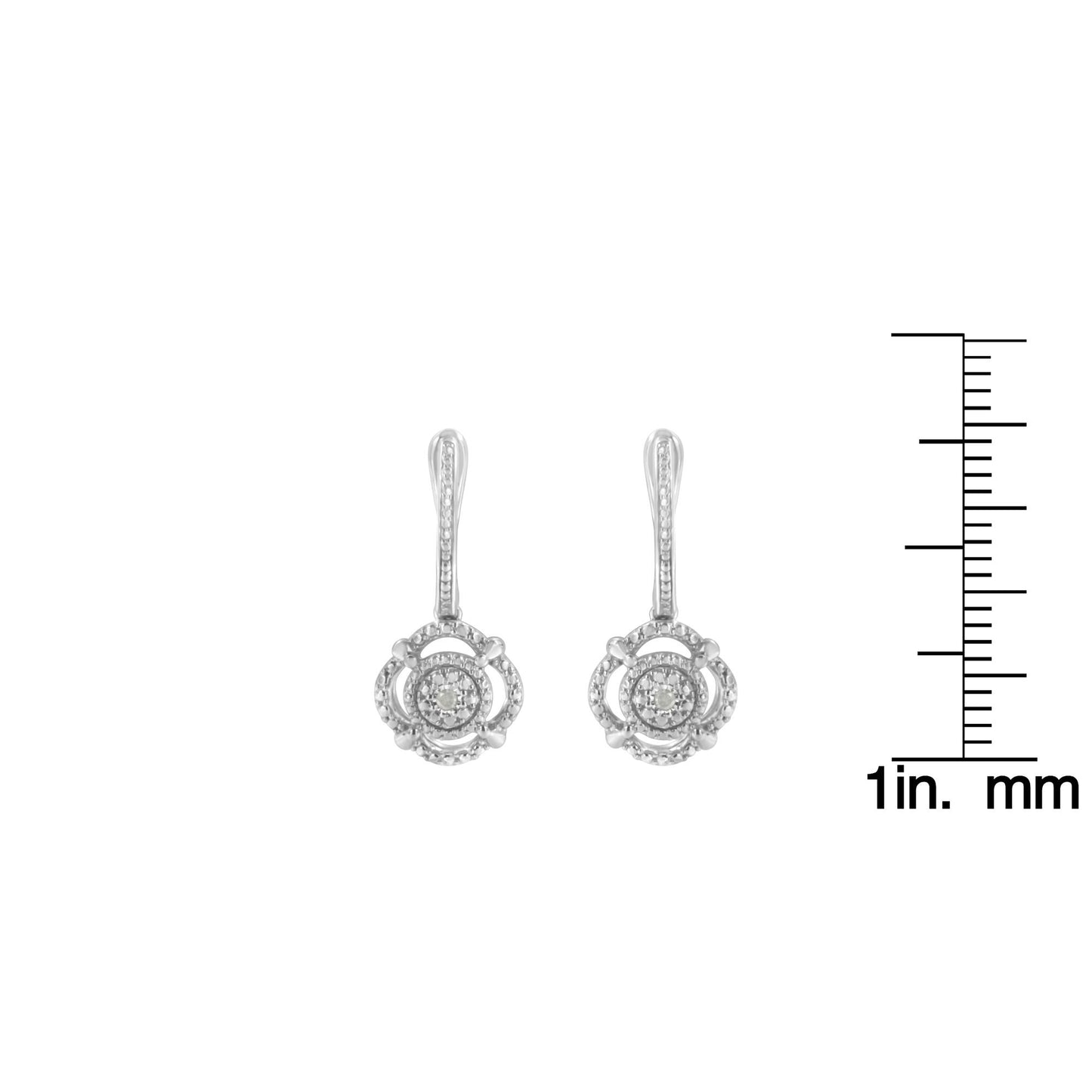 Front view of white metal dangle earrings with round white gemstones, shown next to a ruler for size reference.