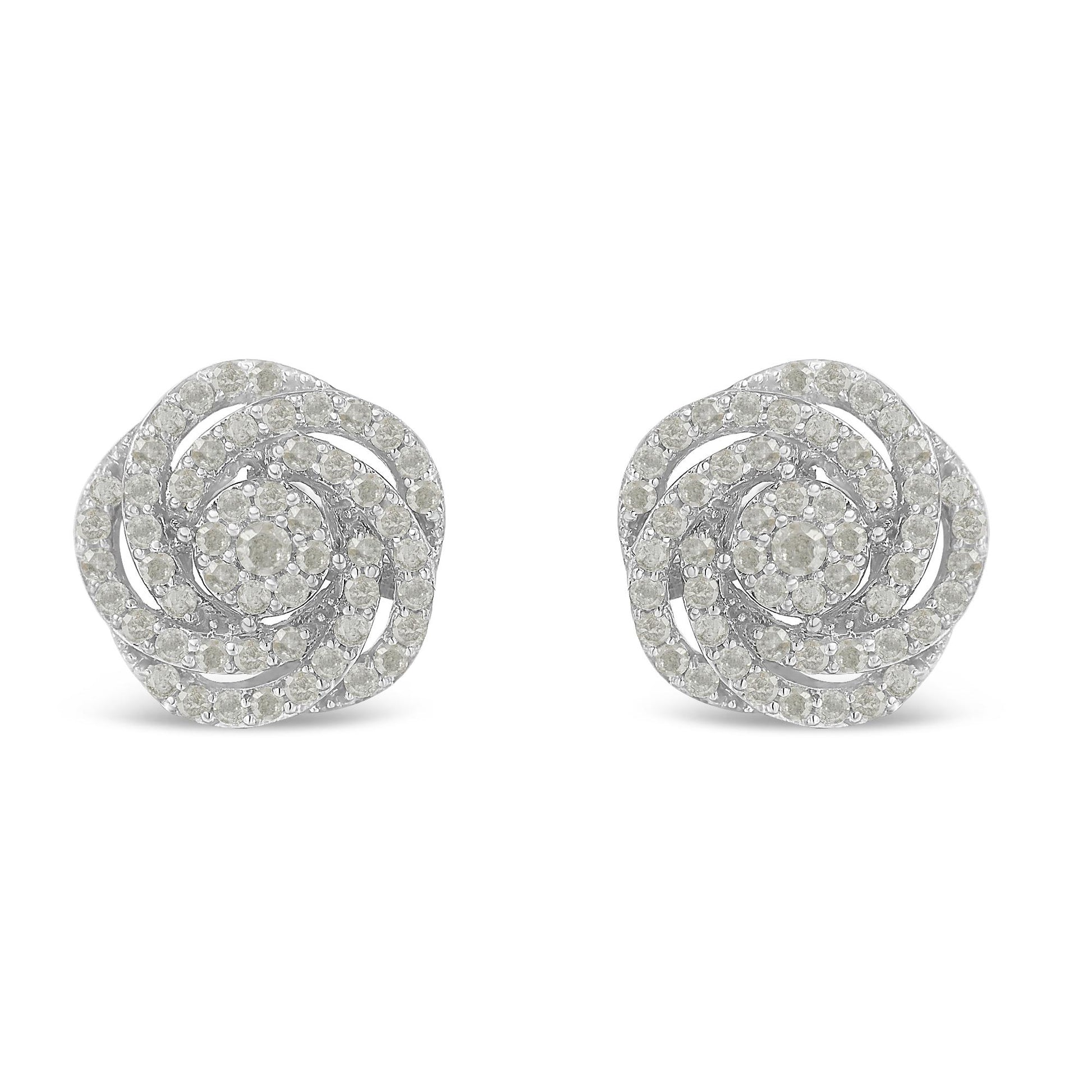 Front view of white metal earrings designed with spiraling rows of round white gemstones in prong settings.