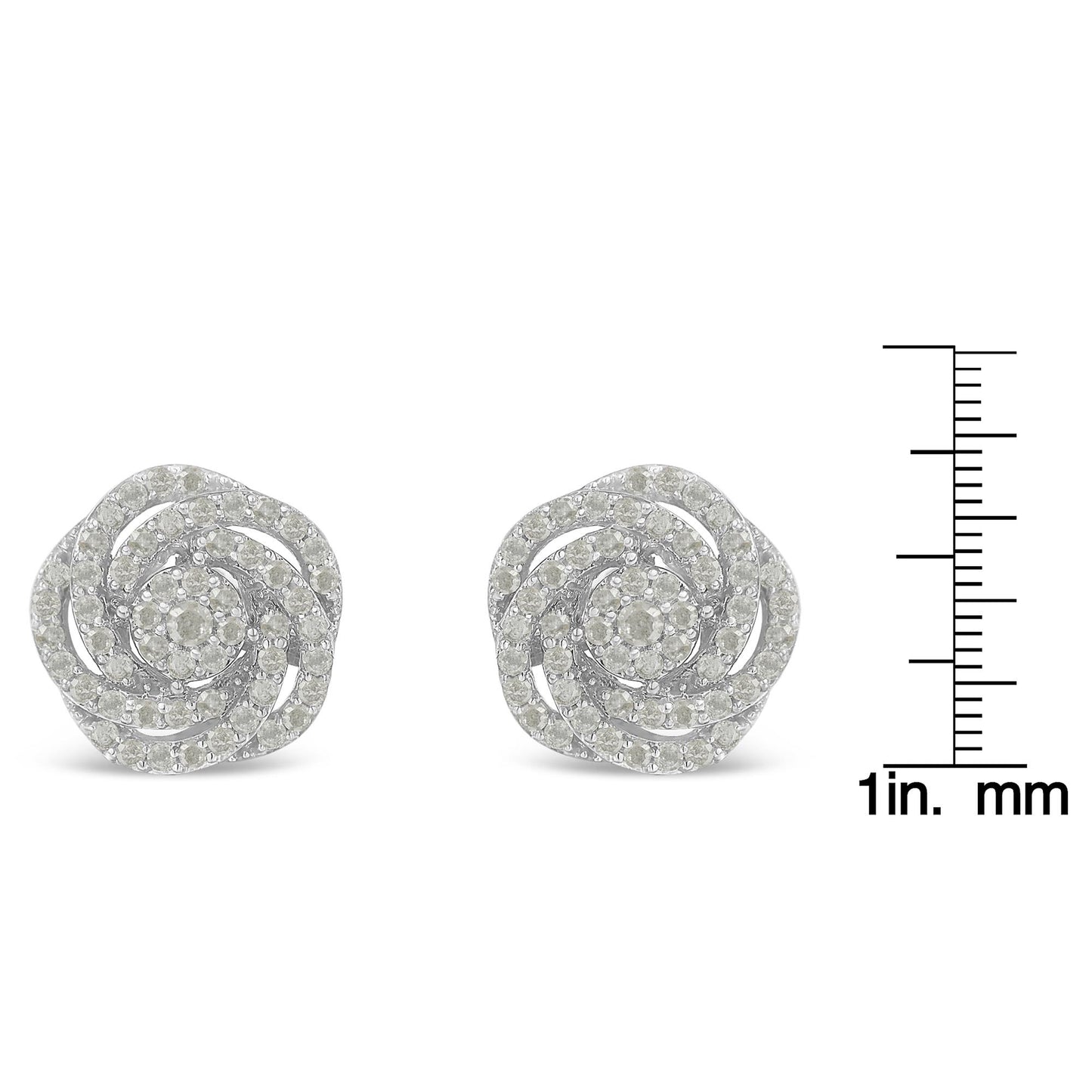 Pair of white metal round cluster earrings with multiple white gemstones in a swirling design, shown from the front on a ruler for size reference.