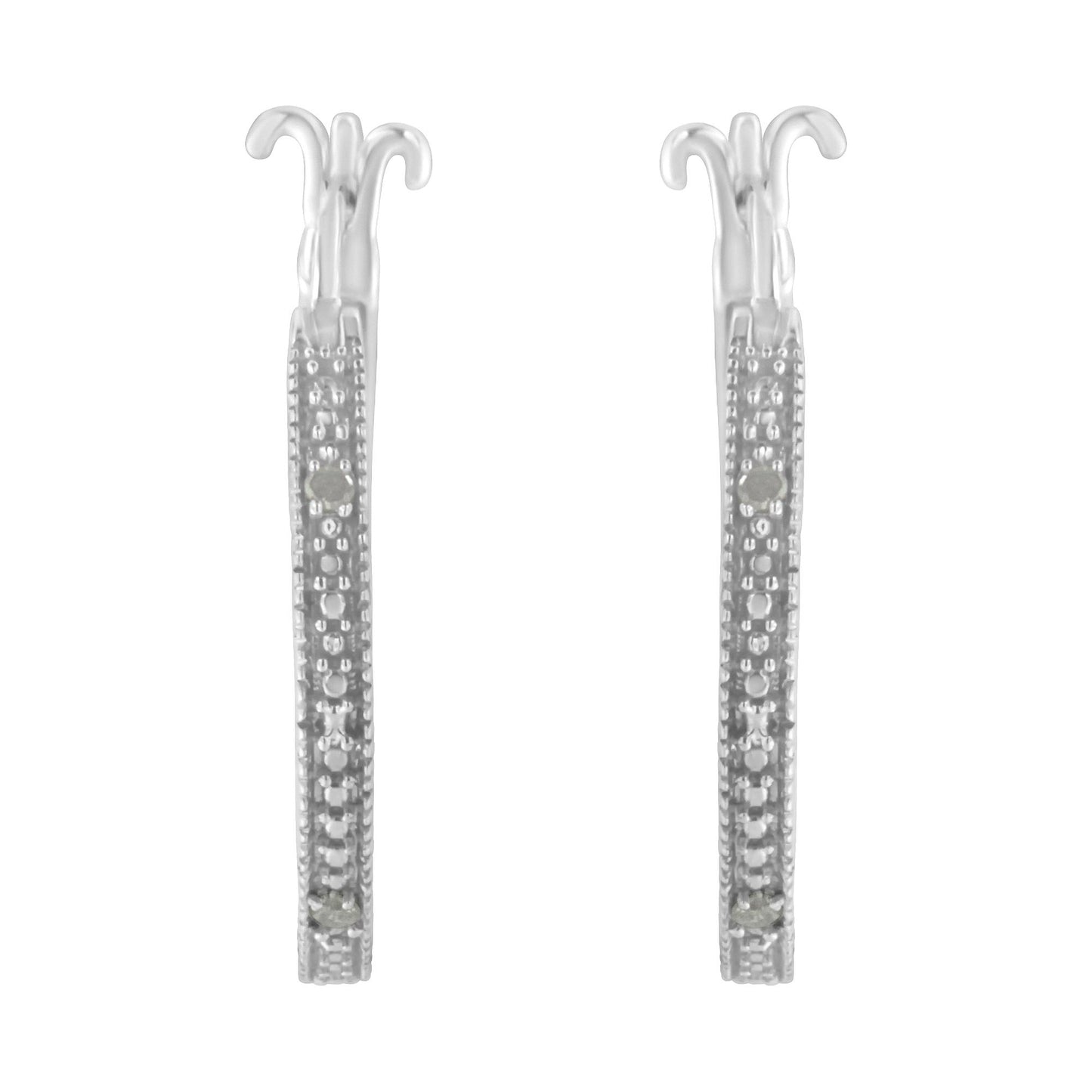 Front-facing shot of a pair of white metal earrings with pave-set round white gemstones along the visible front edges.
