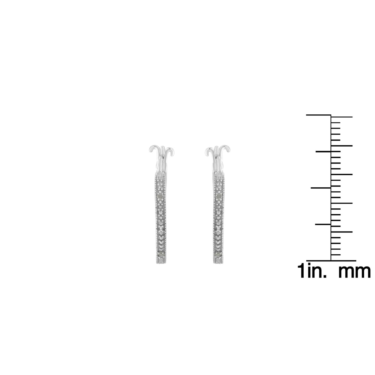 Pair of white metal hoop earrings with round pave-set white gemstones, shown from the side on a scale for size reference.