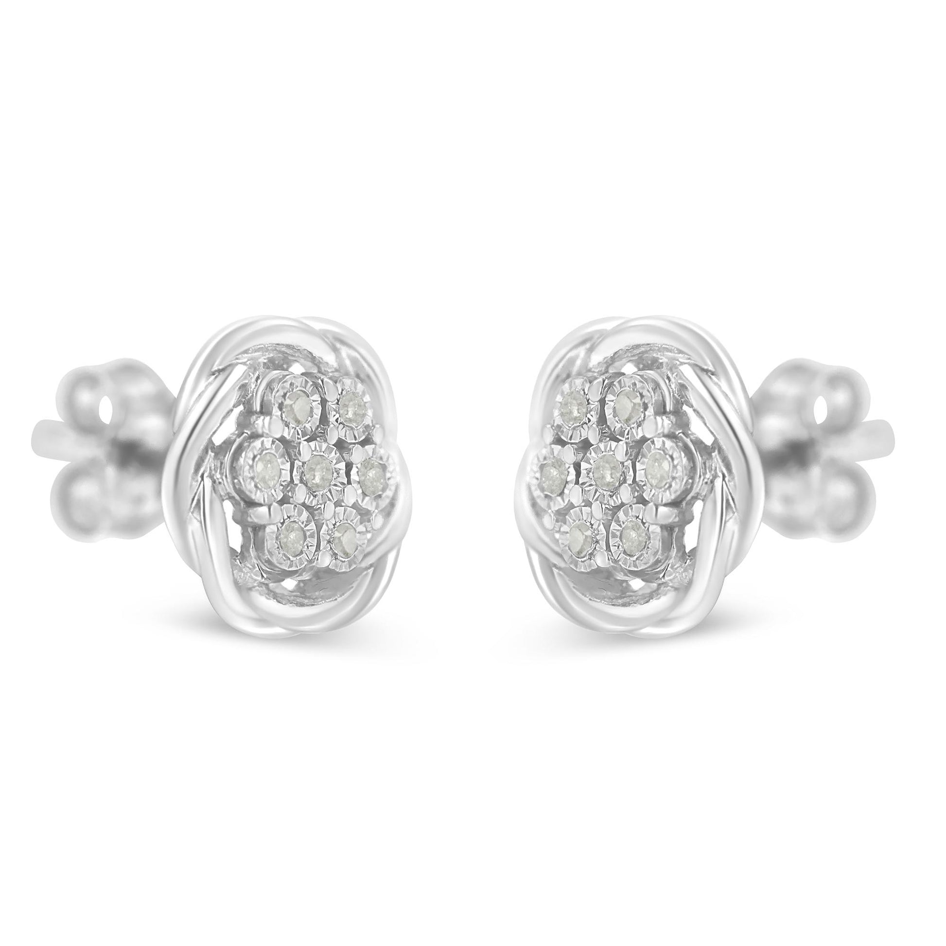Front-facing close-up of a pair of white metal stud earrings with round white gemstones in a cluster setting.
