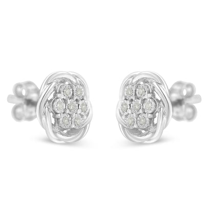 Front-facing close-up of a pair of white metal stud earrings with round white gemstones in a cluster setting.