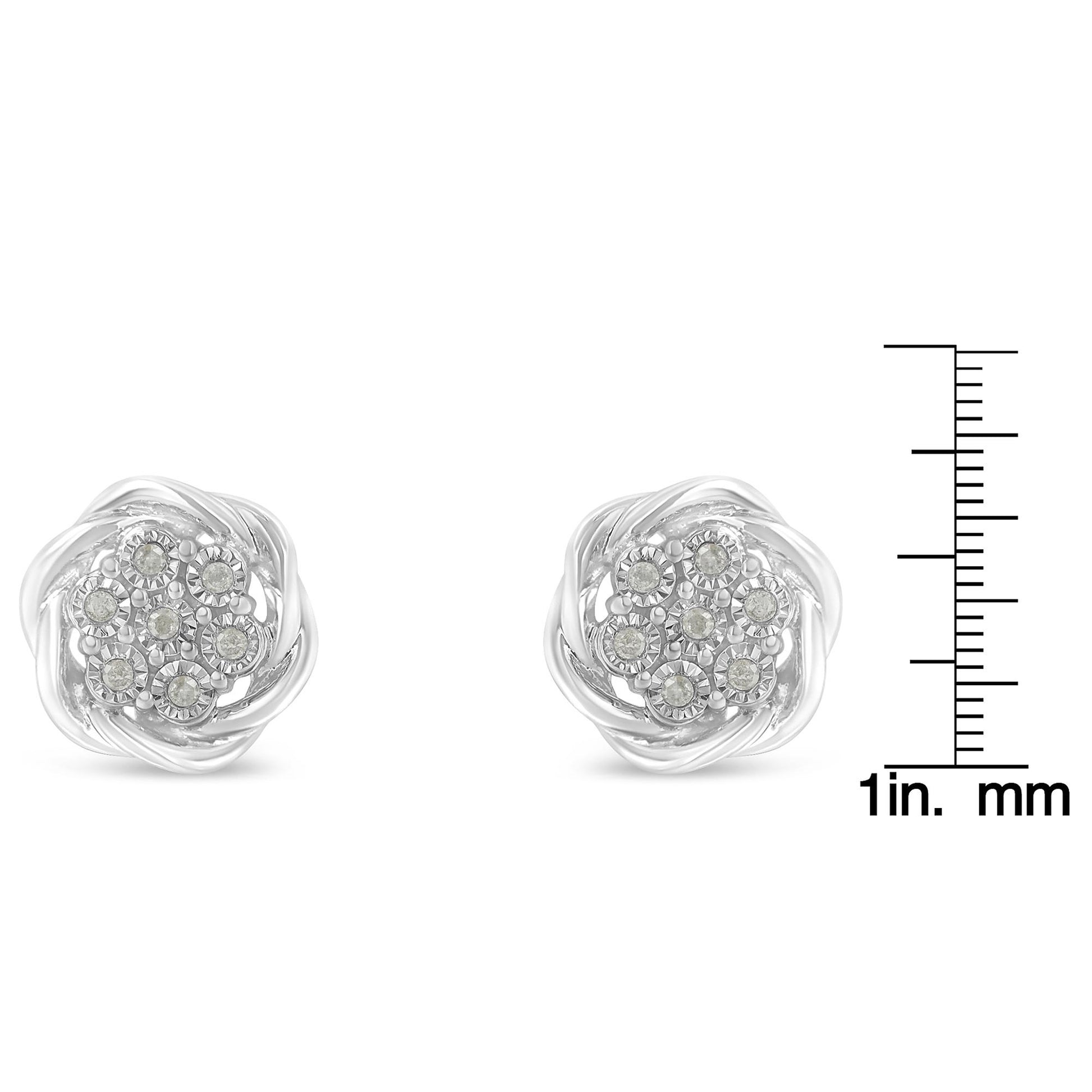 Pair of white metal round cluster earrings with white gemstones in miracle setting, shown front view, placed next to a ruler for size reference.