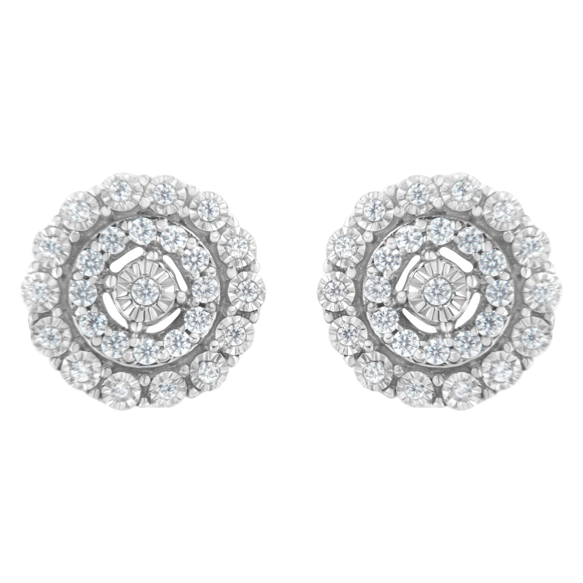 Front view of a pair of round white metal earrings with multiple small white gemstones in a pave setting arranged in concentric circles.