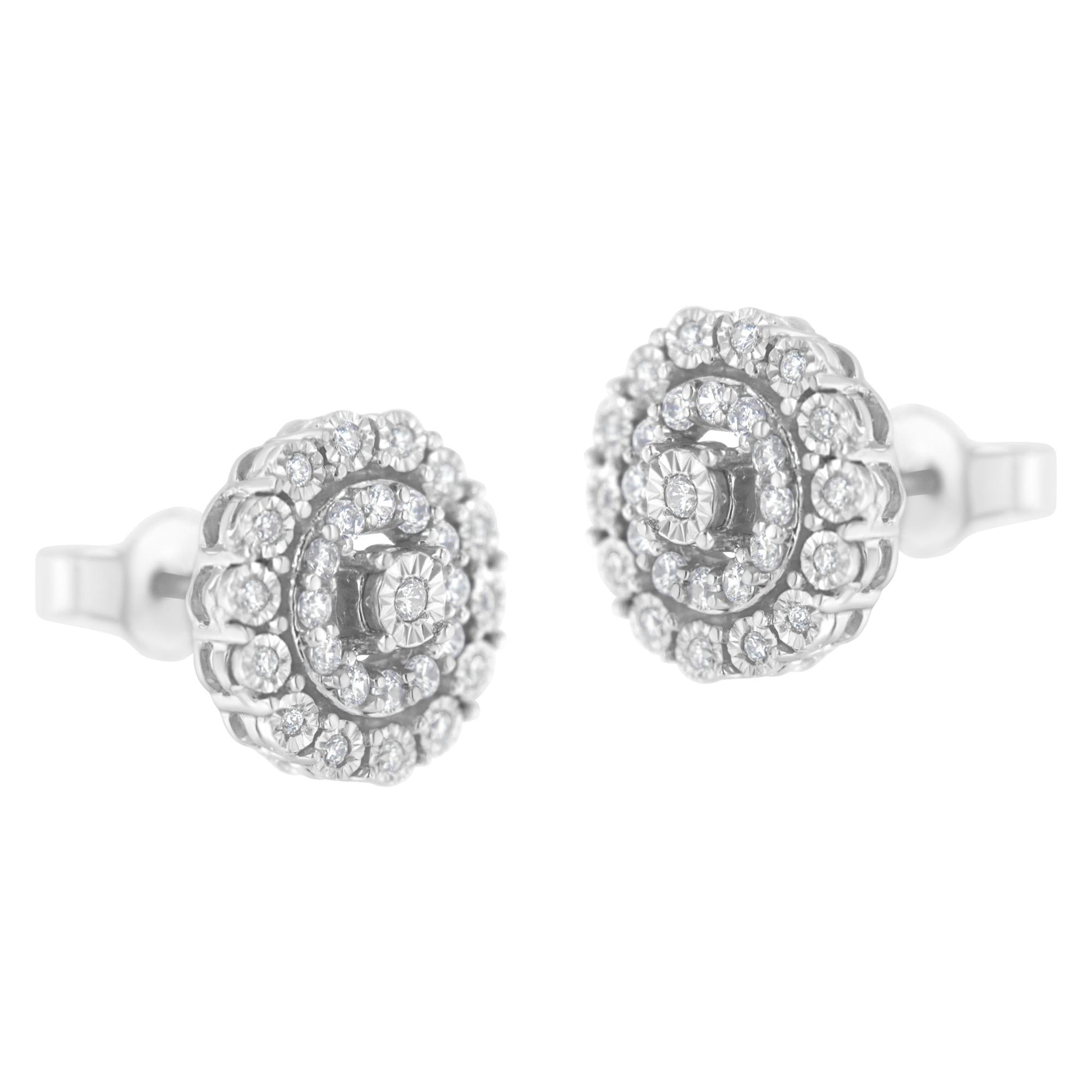 Pair of white metal round stud earrings with multiple white gemstones in a pave setting, shown from a front angle.