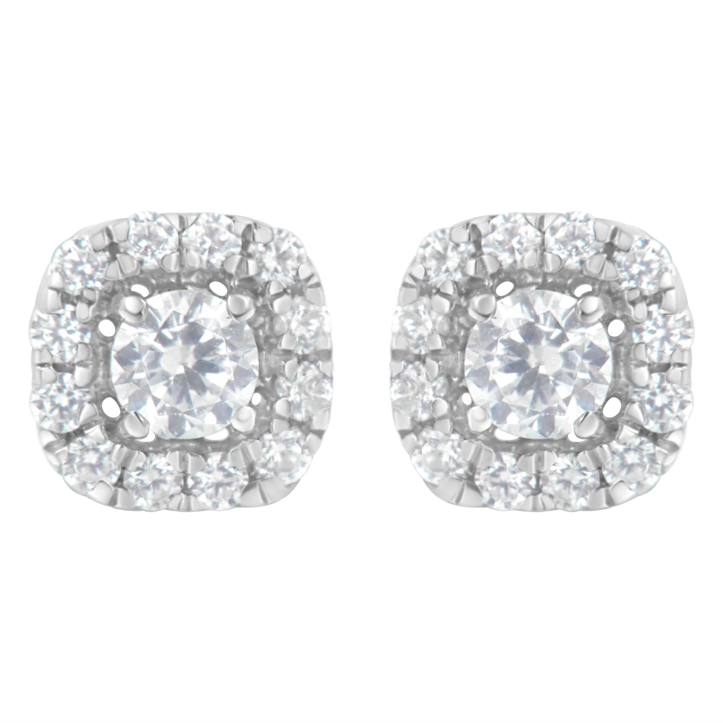 Pair of white metal stud earrings with a central round white gemstone in four-prong settings, surrounded by a halo of smaller round white gemstones in a pave setting, shown from a front angle.