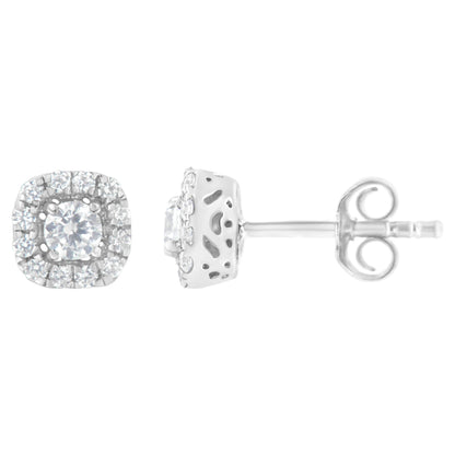Front and side views of a pair of white metal earrings with a central round white gemstone in a 4-prong setting, surrounded by a halo of smaller round white gemstones in a pave setting.