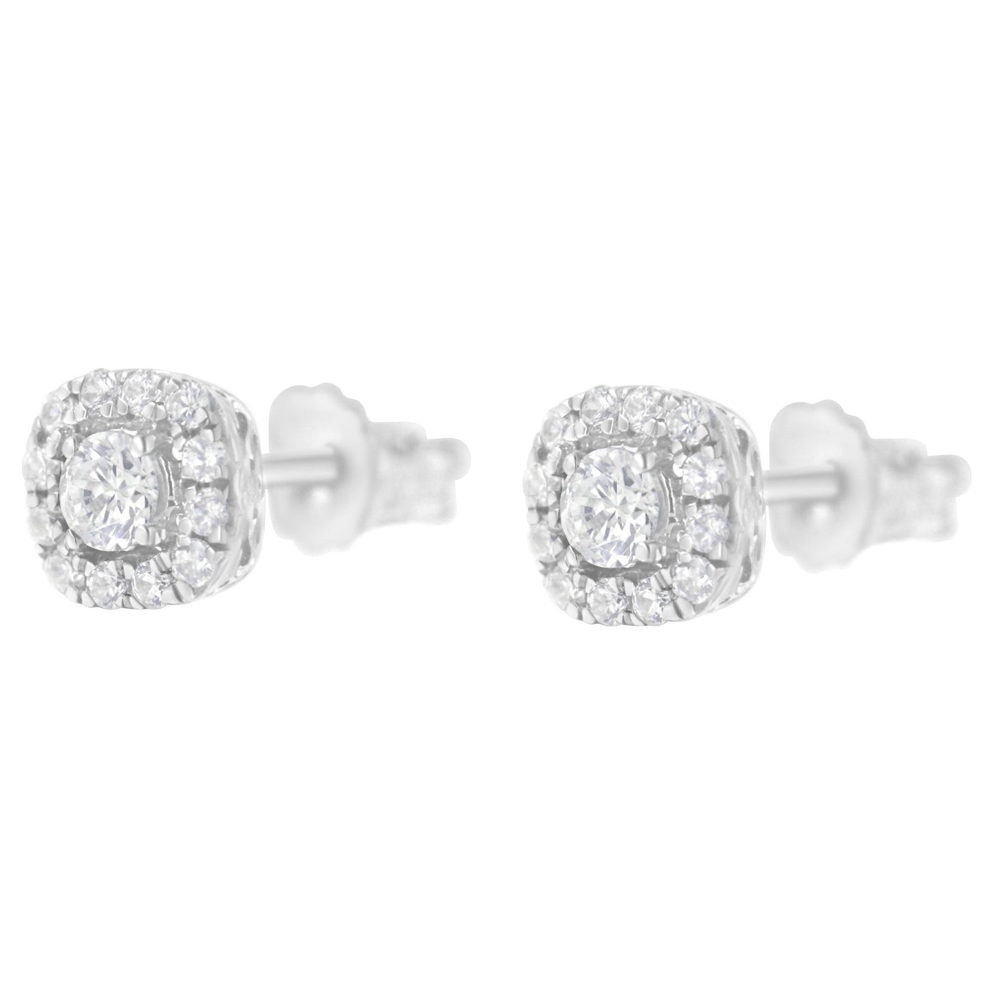 Front angled view of white metal stud earrings with a central round white gemstone in a four-prong setting surrounded by smaller round white gemstones in pave setting.