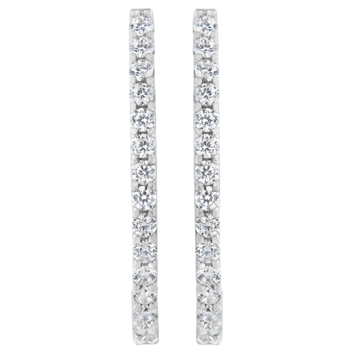 Front-facing shot of a pair of white metal earrings each set with a vertical line of round white gemstones in prong settings.
